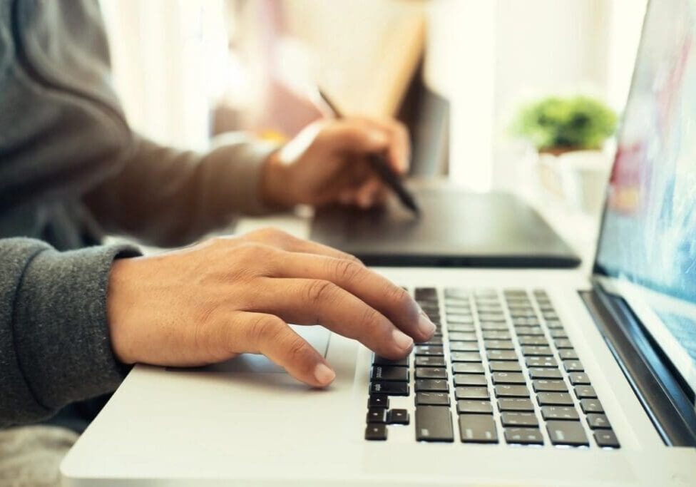 A person typing on a laptop computer.